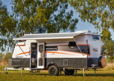 Modern caravan parked in grassy area